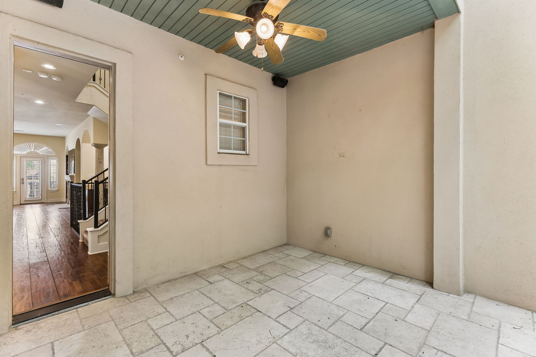 1529 Barton Springs Road, Unit 9 Austin, TX 78704 - Photo 19 of 37 Outdoor patio space featuring large format stone tile flooring, a pale green tongue and groove ceiling, and a ceiling fan