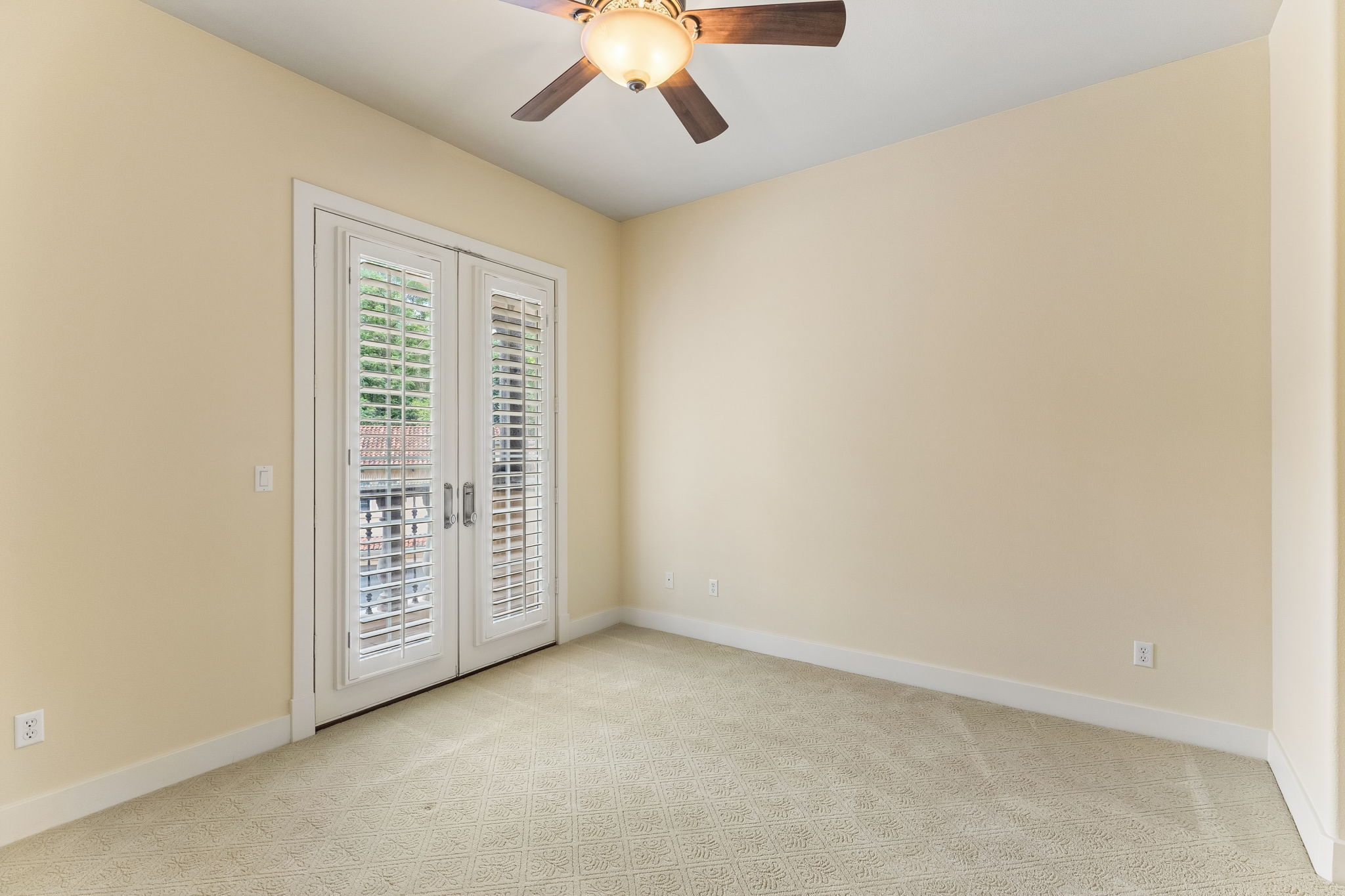 1529 Barton Springs Road, Unit 9 Austin, TX 78704 - Photo 23 of 37 This bedroom features neutral-toned carpeting, light-colored walls, and a ceiling fan with integrated lighting