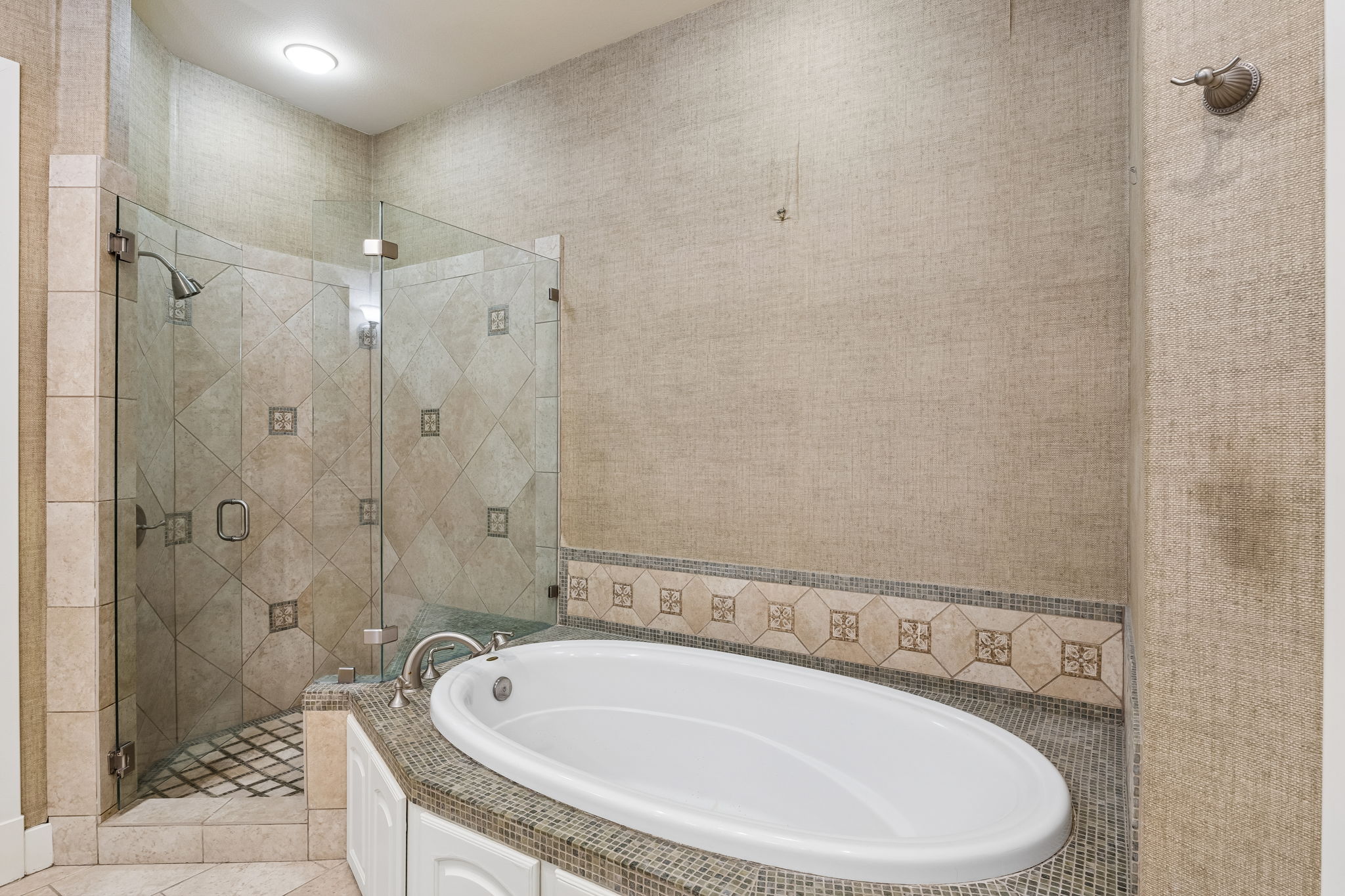 1529 Barton Springs Road, Unit 9 Austin, TX 78704 - Photo 31 of 37 The bathroom features a glass-enclosed shower with tile work, an oval soaking tub, and a decorative tiled surround