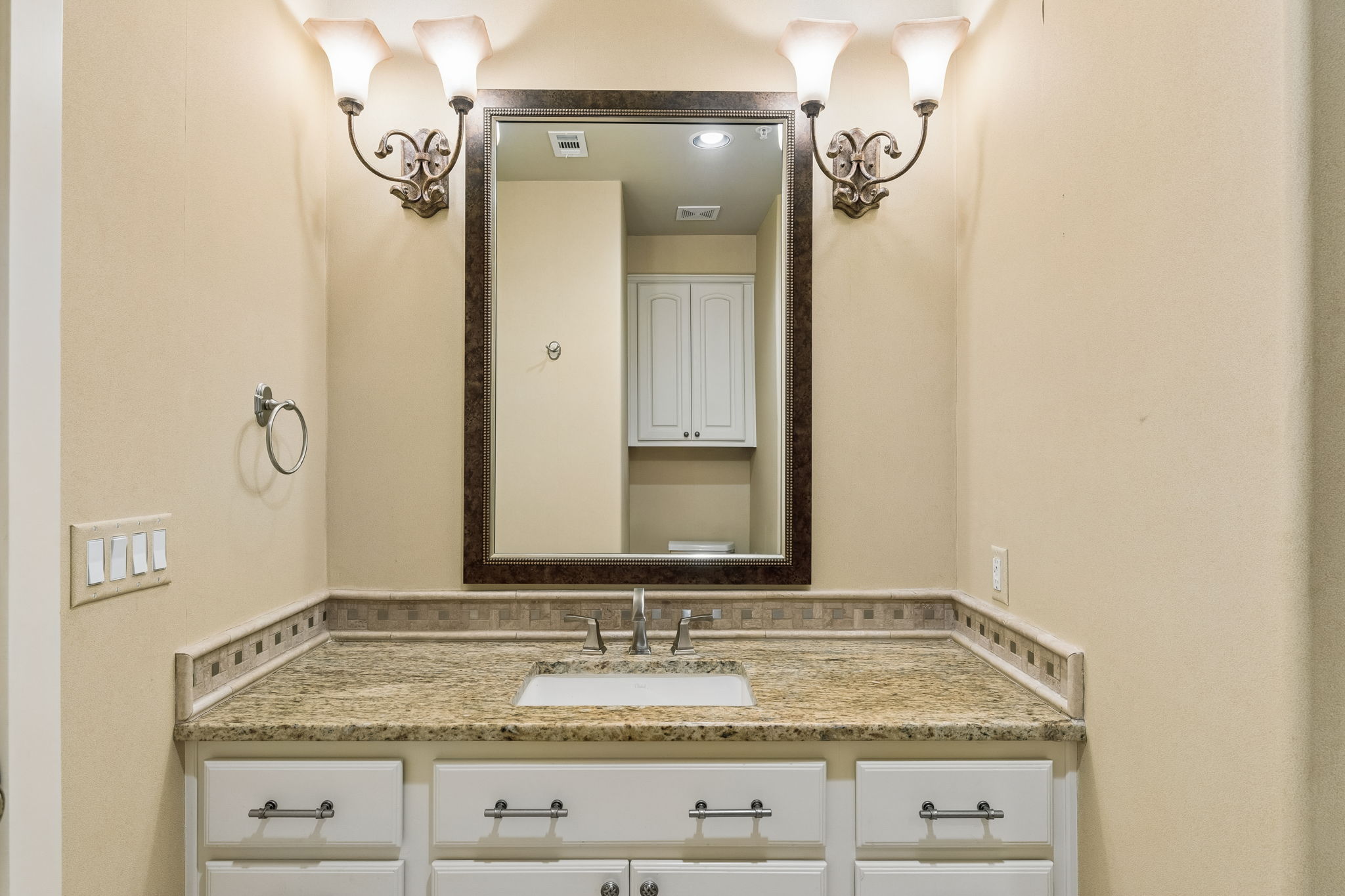 1529 Barton Springs Road, Unit 9 Austin, TX 78704 - Photo 6 of 37 The bathroom features a vanity with a granite countertop, a single basin sink, and white cabinetry