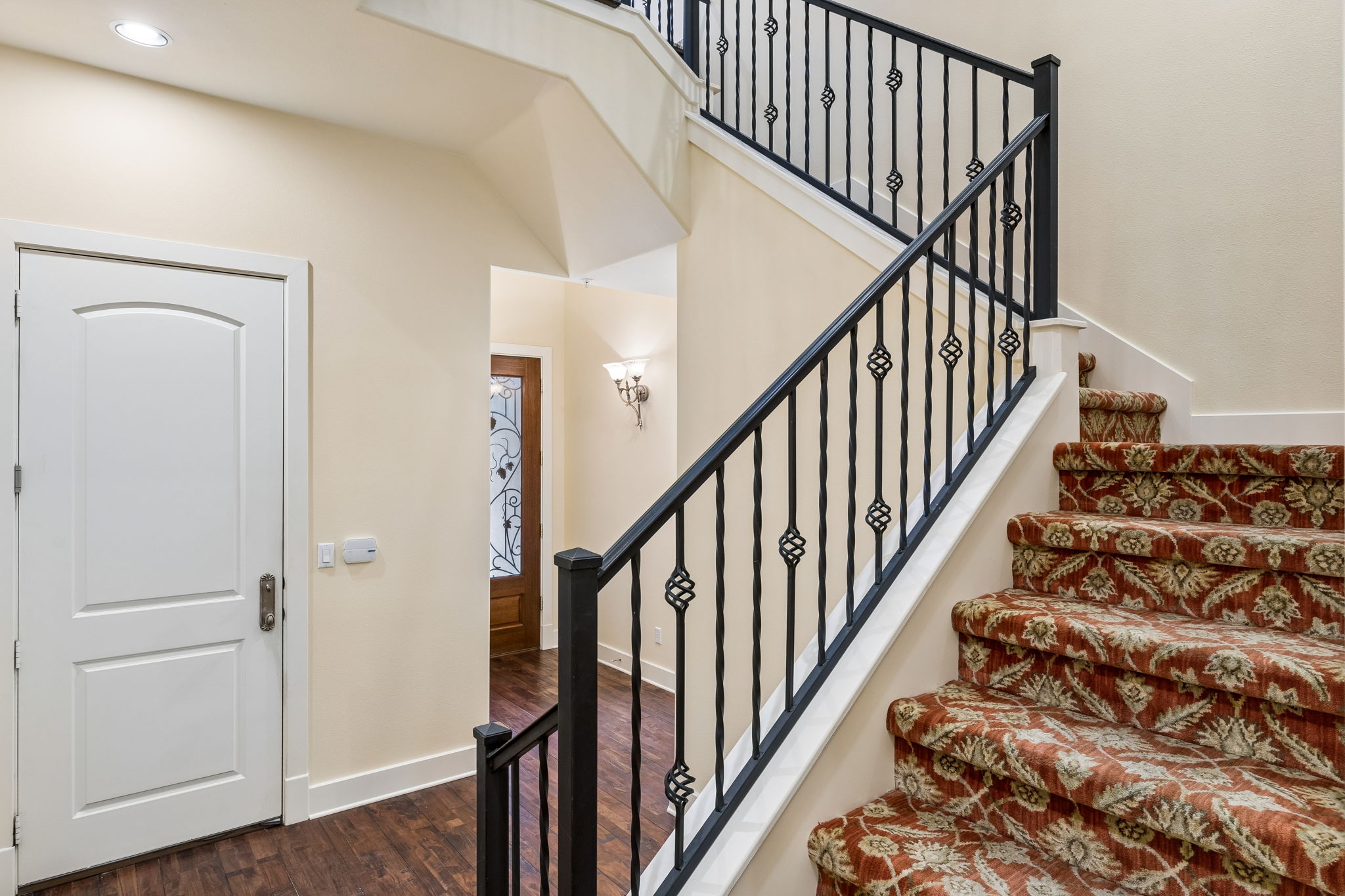 1529 Barton Springs Road, Unit 9 Austin, TX 78704 - Photo 8 of 37 Staircase featuring decorative wrought iron railings and a custom wool carpet runner