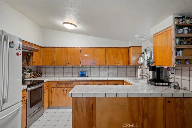 a kitchen with stainless steel appliances granite countertop a sink and cabinets