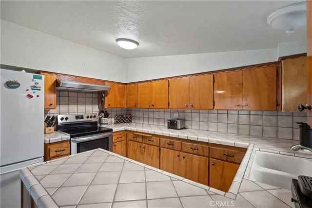 a kitchen with a stove and a refrigerator