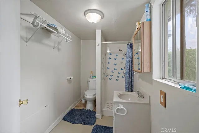 a living room with a baby crib and a couch