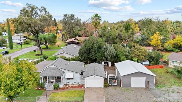 a view of a house with a yard and sitting area