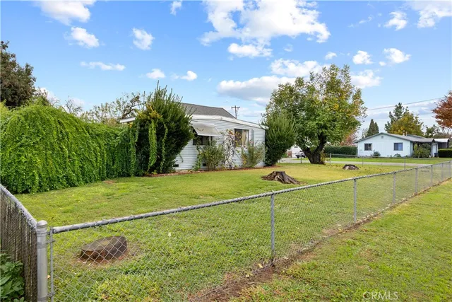 an aerial view of a house with a yard and lake view