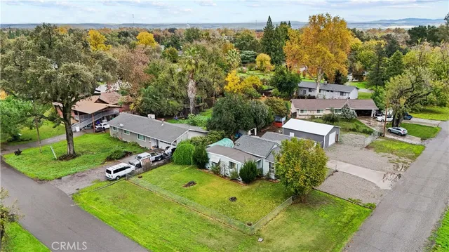 an aerial view of multiple houses with yard