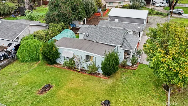 an aerial view of a house with a yard