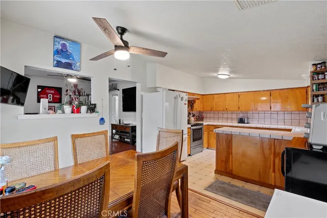 a kitchen with a sink a counter top space appliances and cabinets