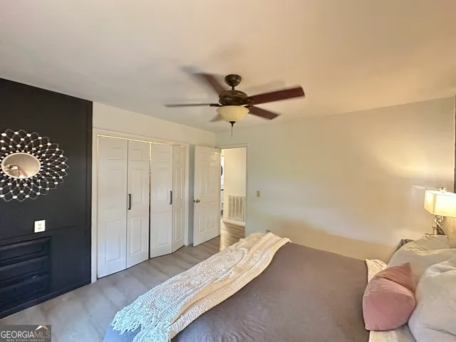 a bedroom with bed and a chandelier