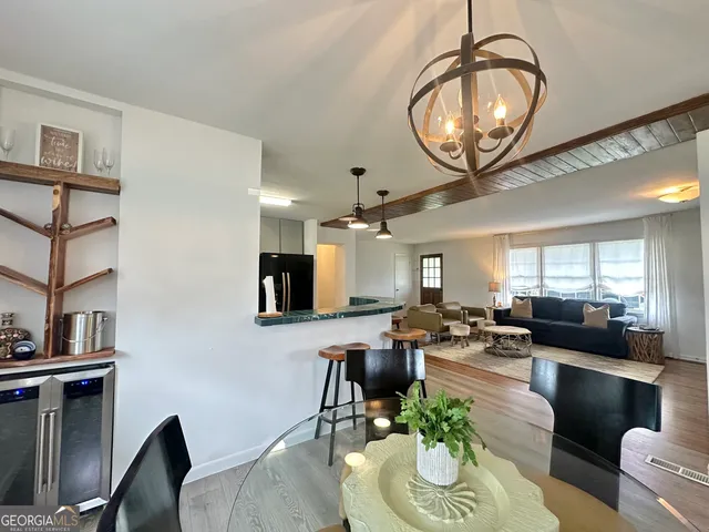 a living room with fireplace furniture and a potted plant