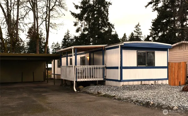 a view of a house with a yard and deck