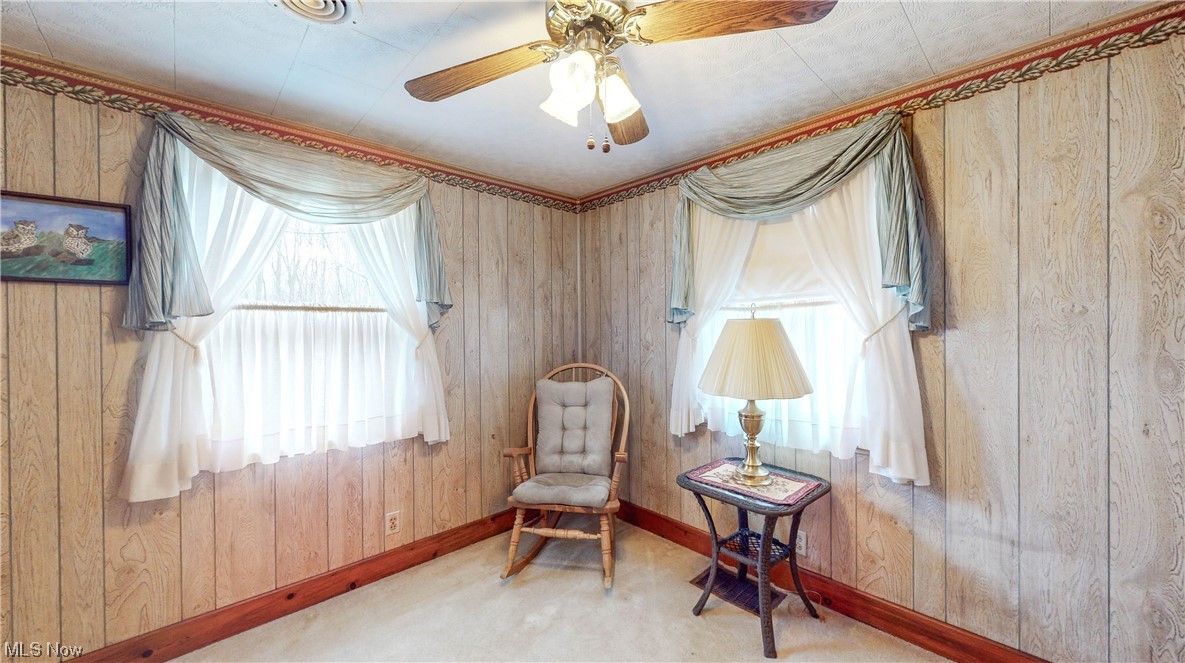 466 Pine Lake Road Sebring, OH 44672 - Photo 27 of 30 Bedroom with wooden walls, light colored carpet, and ceiling fan