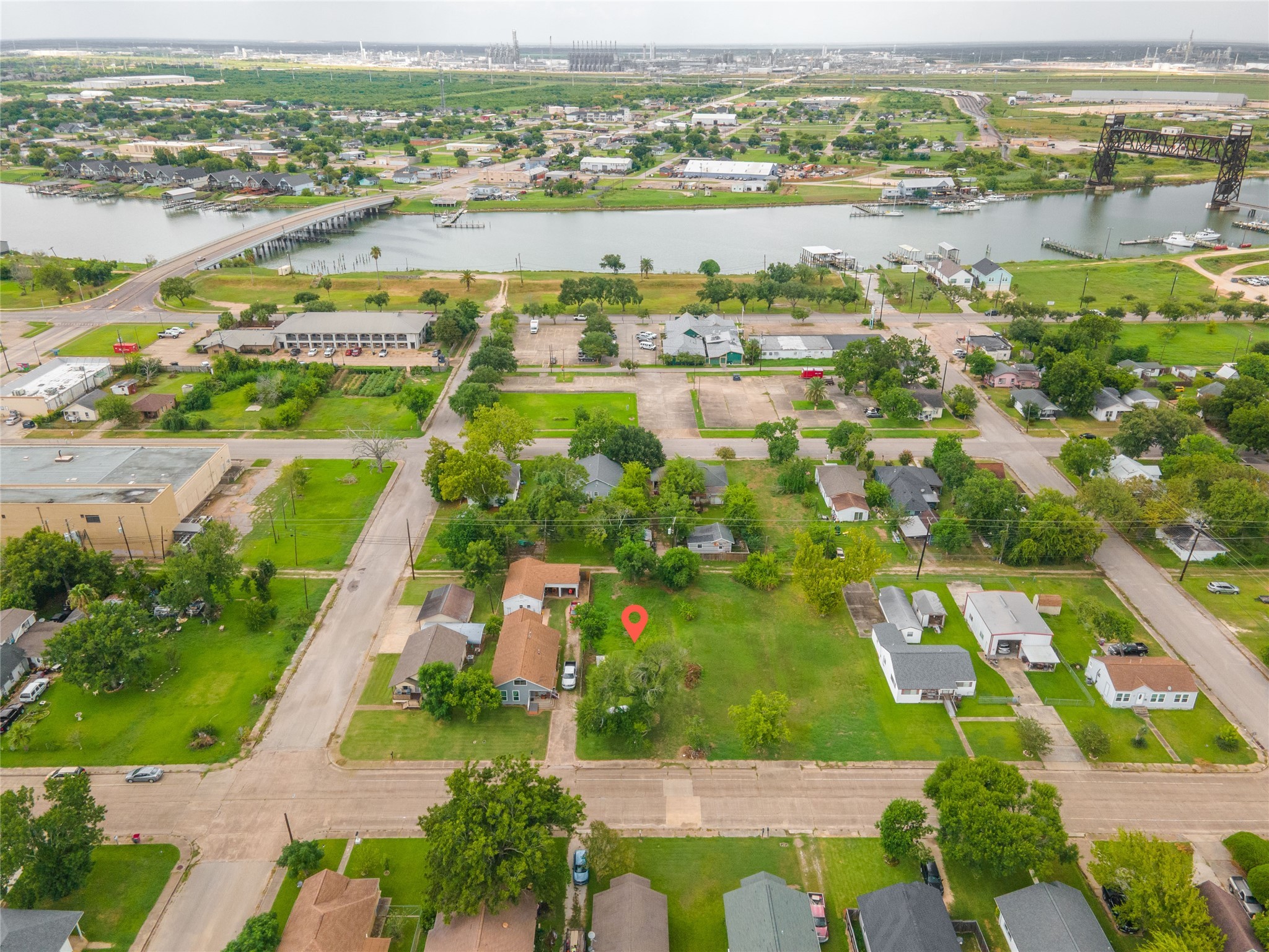 an aerial view of residential houses with outdoor space and river