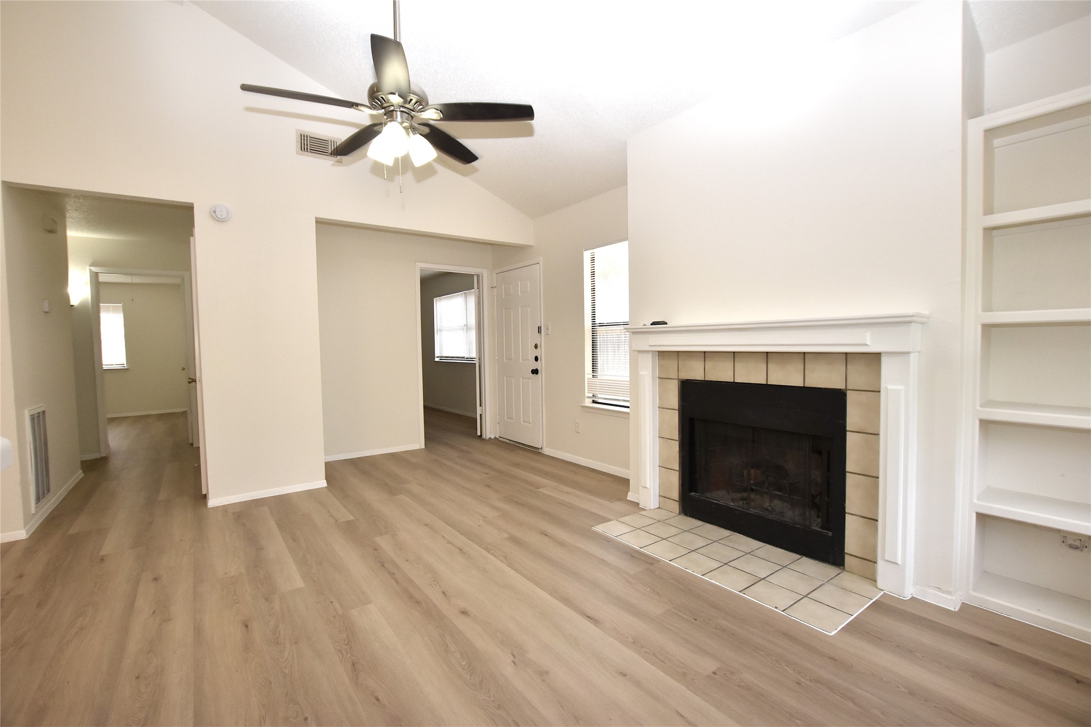 2801 West Slaughter Lane, Unit A Austin, TX 78748 - Photo 1 of 15 a view of a livingroom with a fireplace and a ceiling fan