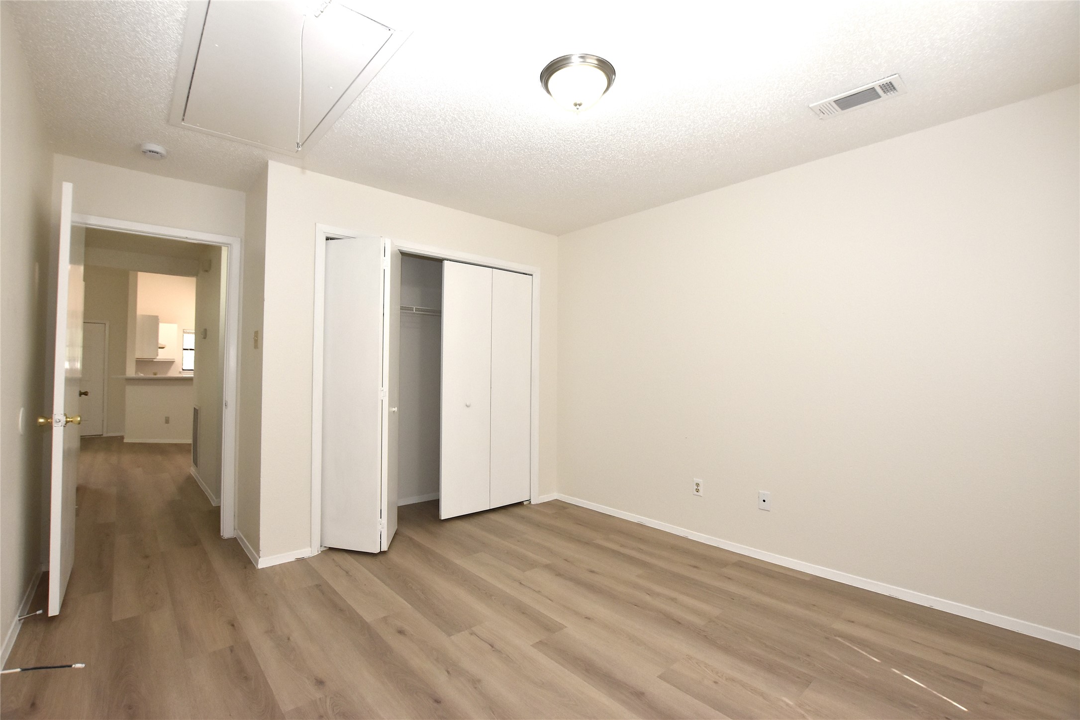 2801 West Slaughter Lane, Unit A Austin, TX 78748 - Photo 13 of 15 an empty room with wooden floor and a bathroom