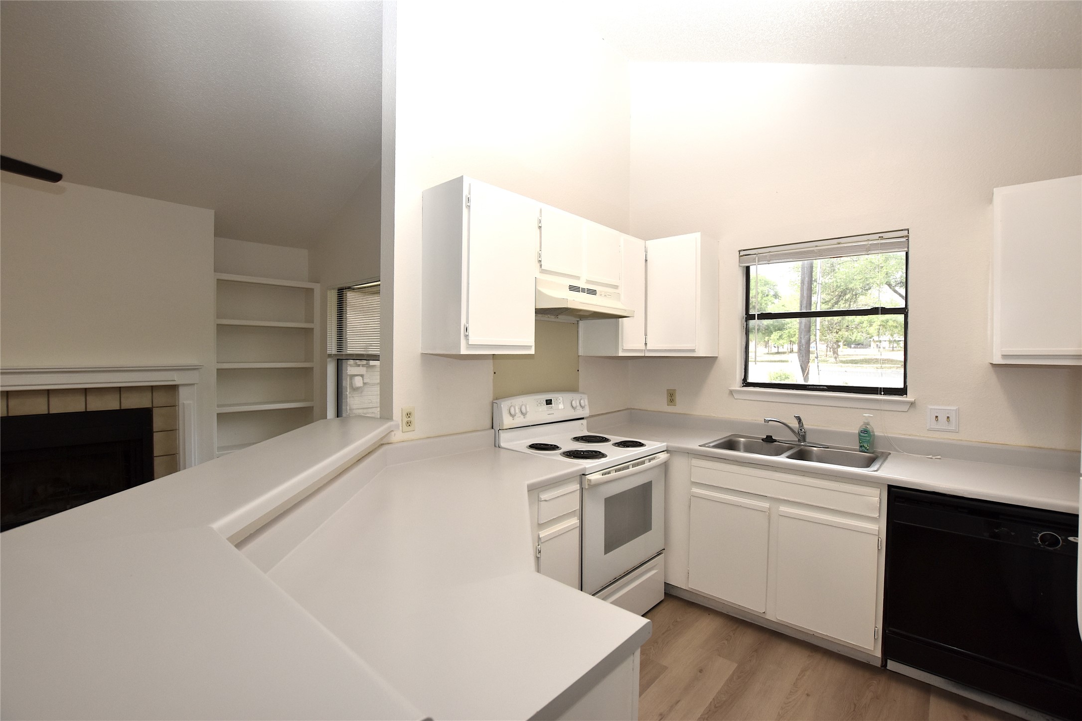 2801 West Slaughter Lane, Unit A Austin, TX 78748 - Photo 7 of 15 a kitchen with a stove a sink and a window