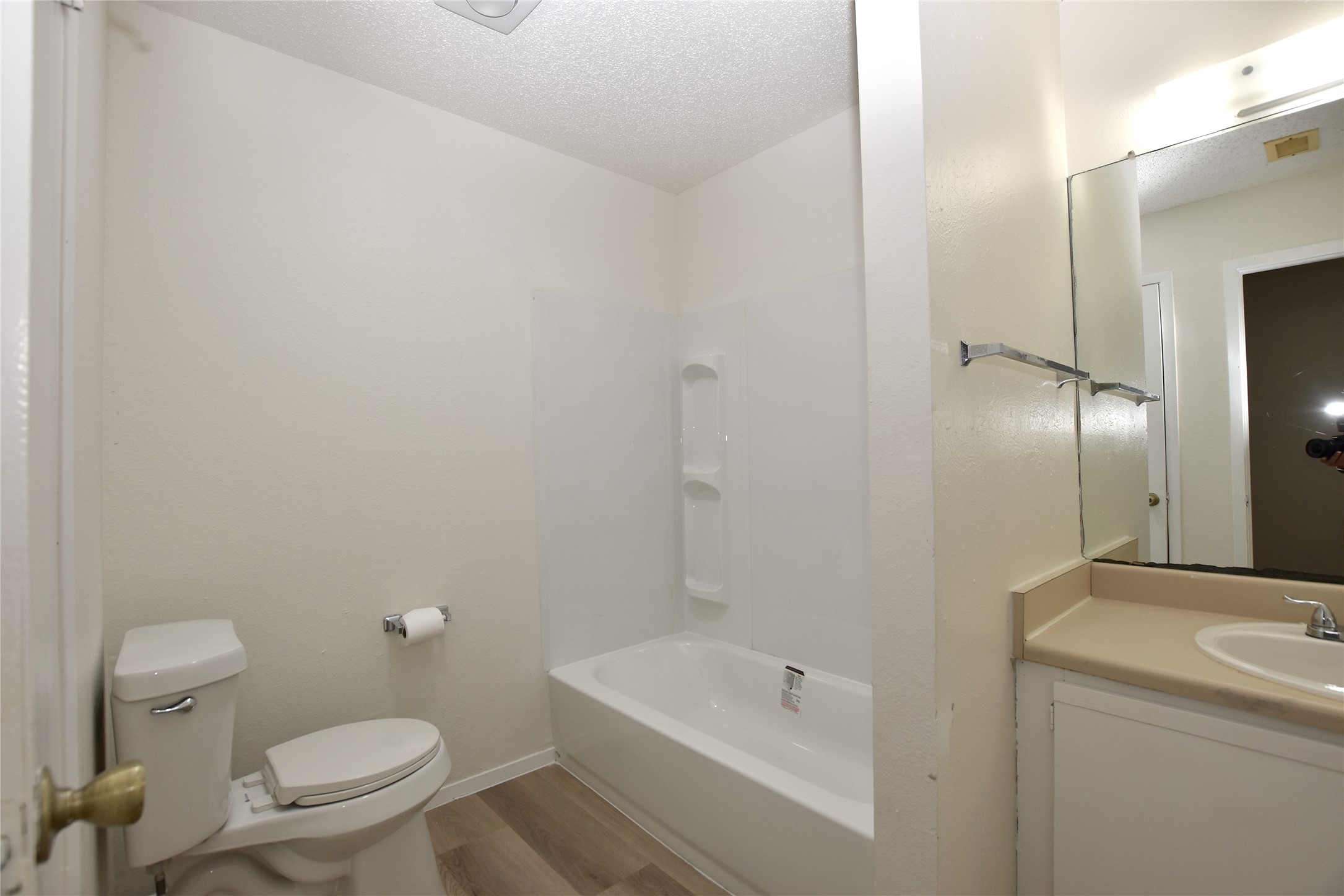 2801 West Slaughter Lane, Unit A Austin, TX 78748 - Photo 10 of 15 a bathroom with a sink a toilet and shower