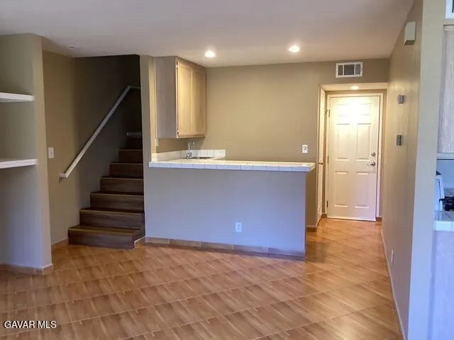 a view of kitchen and hall with wooden floor
