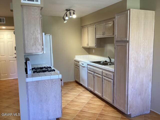 43469 30th Street West, Unit 3 Lancaster, CA 93536 - Photo 5 of 17 a kitchen with granite countertop a sink stove and refrigerator