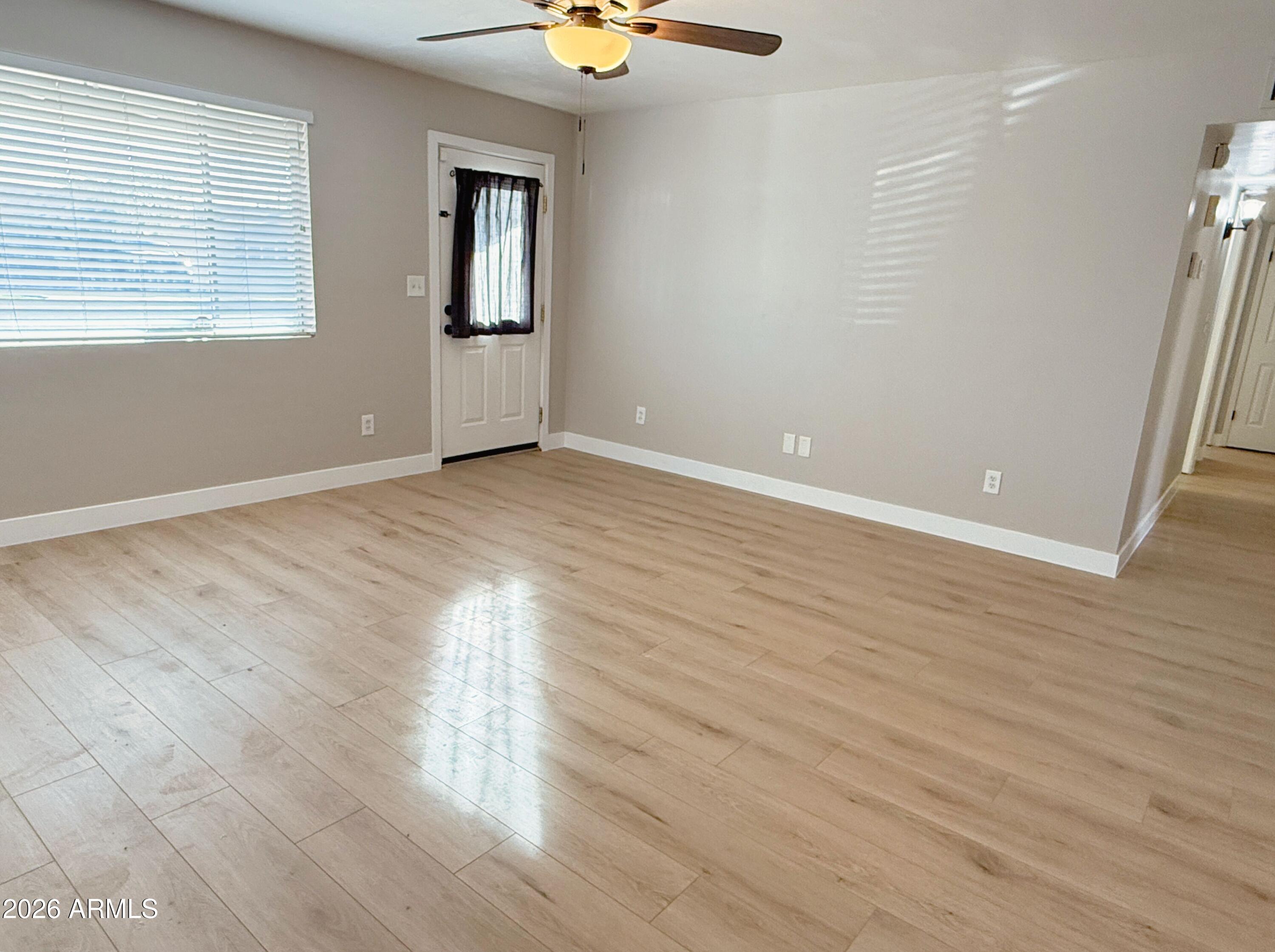 1220 West Romo Jones Street Tempe, AZ 85281 - Photo 5 of 26 wooden floor in an empty room with a window