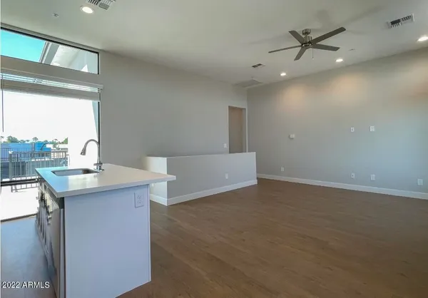 a kitchen with a sink cabinets and wooden floor