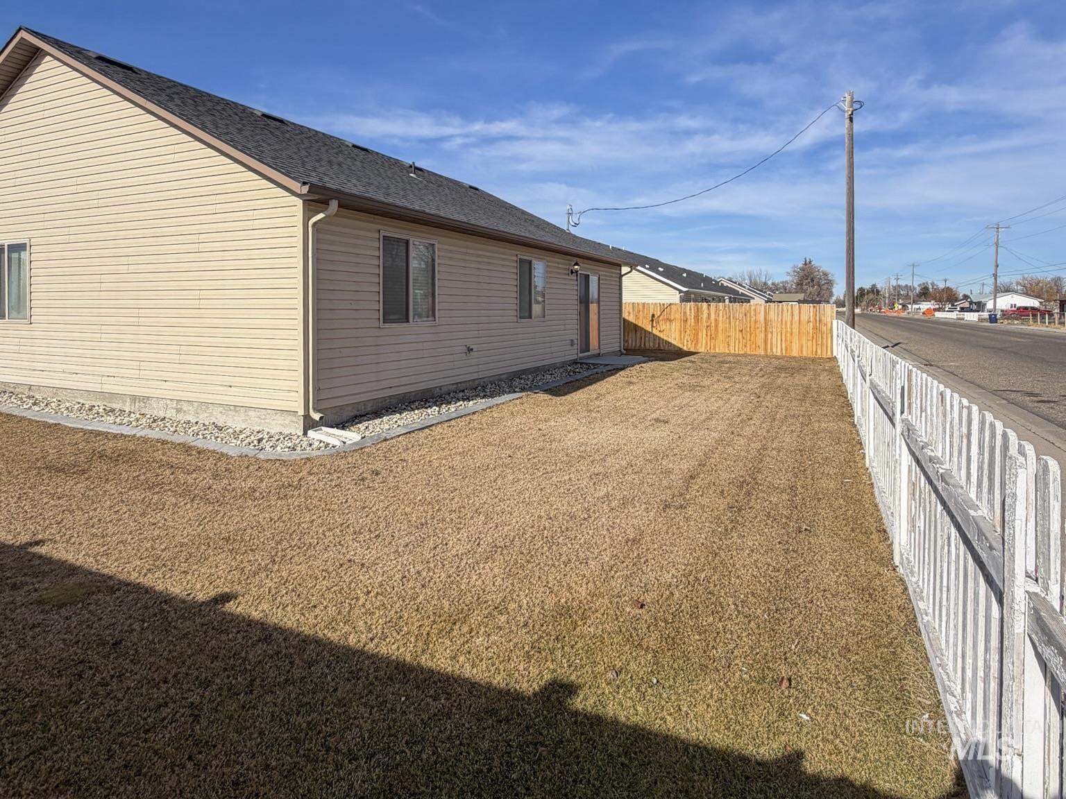 702 Emerald Street Rupert, ID 83350 - Photo 2 of 12 View of side of property featuring roof with shingles