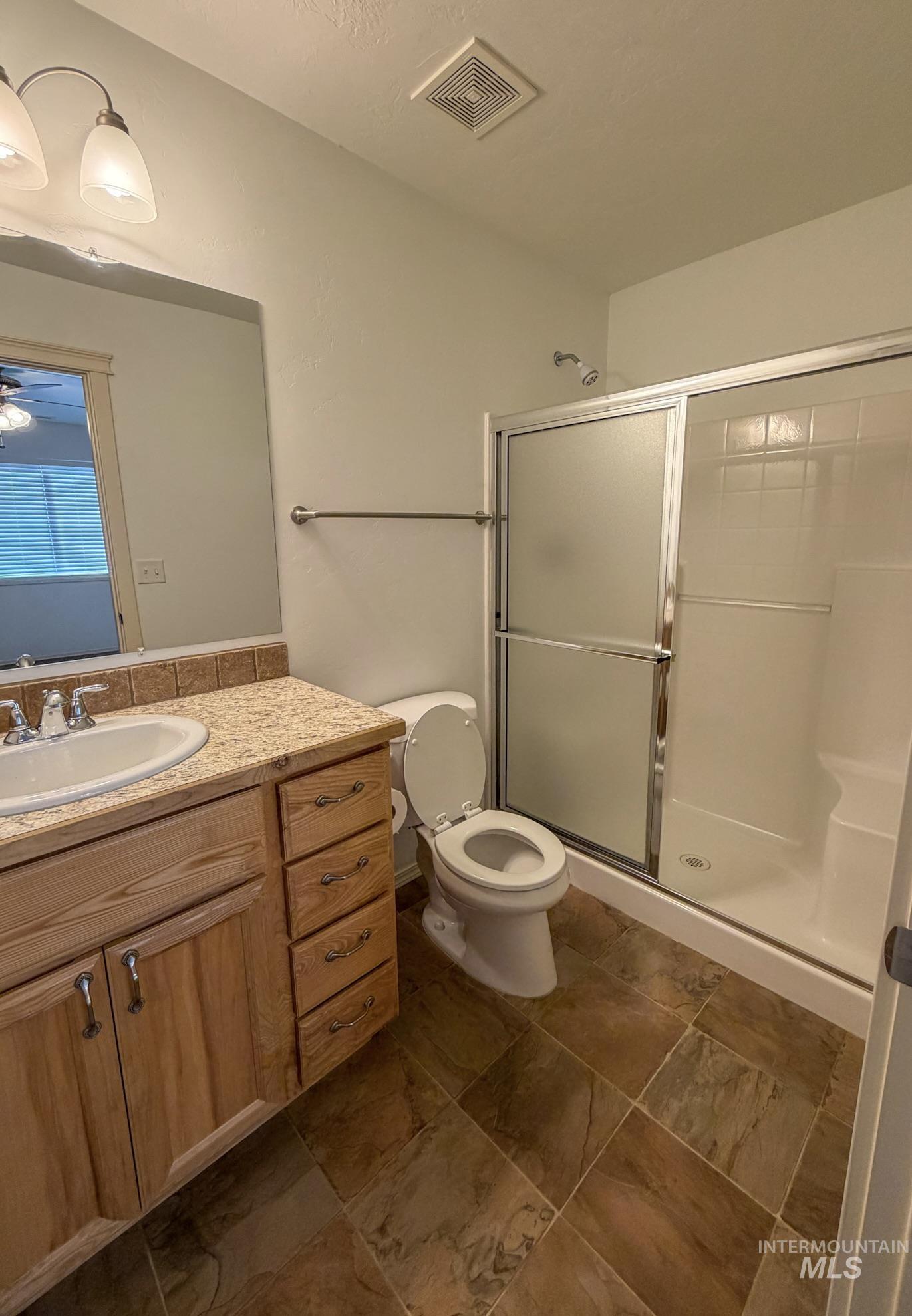 702 Emerald Street Rupert, ID 83350 - Photo 9 of 12 Bathroom with vanity and a stall shower