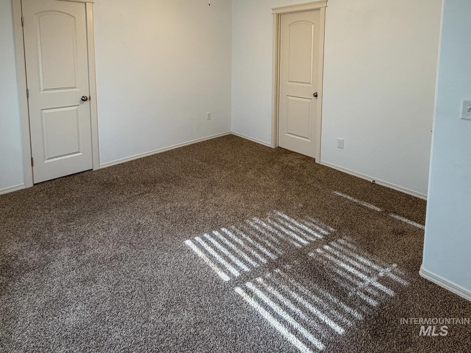 702 Emerald Street Rupert, ID 83350 - Photo 10 of 12 Unfurnished room featuring dark colored carpet