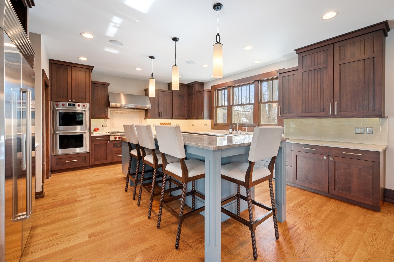 412 Central Avenue Wilmette, IL 60091 - Photo 13 of 69 a kitchen with stainless steel appliances kitchen island granite countertop a table chairs and a refrigerator
