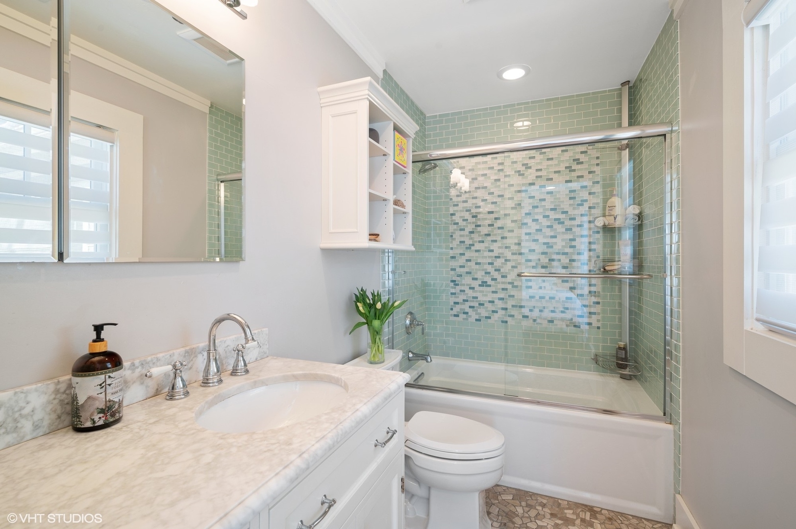 412 Central Avenue Wilmette, IL 60091 - Photo 34 of 69 a bathroom with a granite countertop sink a toilet a mirror a bathtub and shower