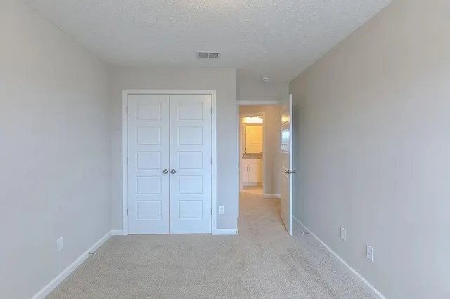 a view of an empty room and closet area