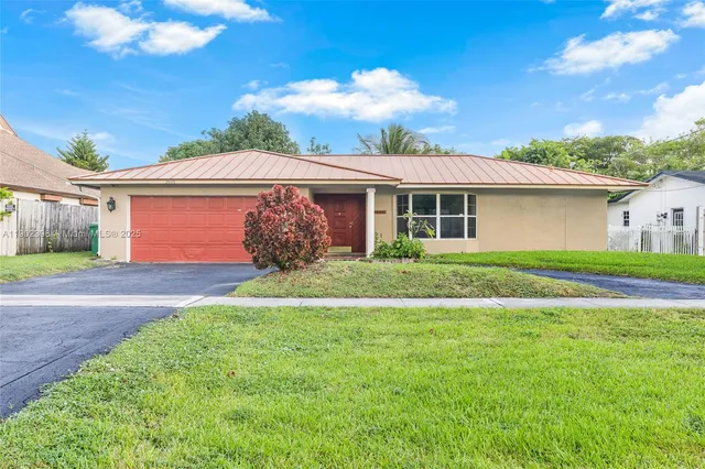 a front view of house with yard and green space