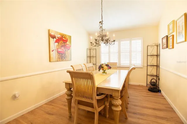 a view of a dining room with furniture and a chandelier