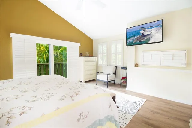 a view of a bedroom with a bed and a window