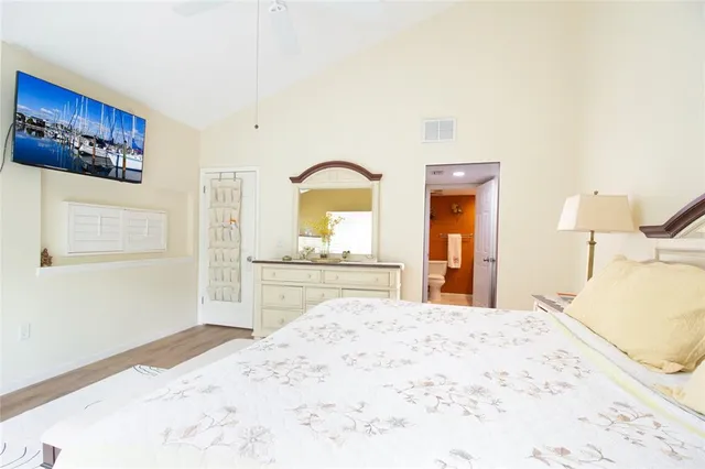 a bedroom with a bed and a dresser with mirror