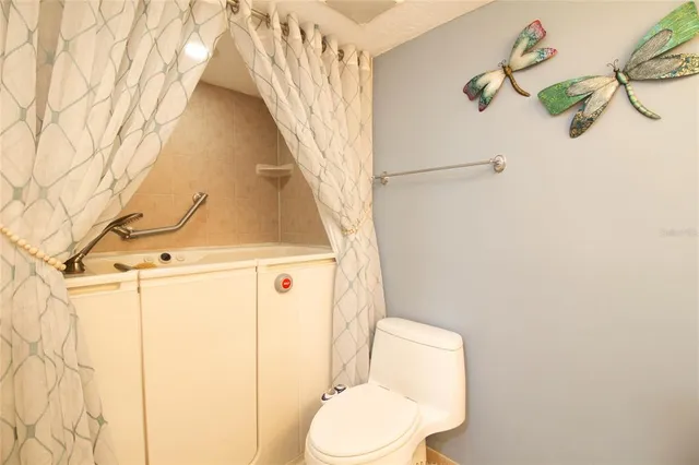 a bathroom with a toilet sink and shower