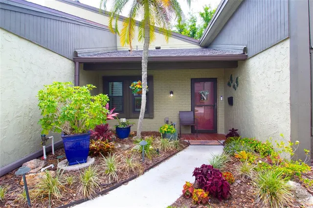 a front view of a house with a chairs and a table