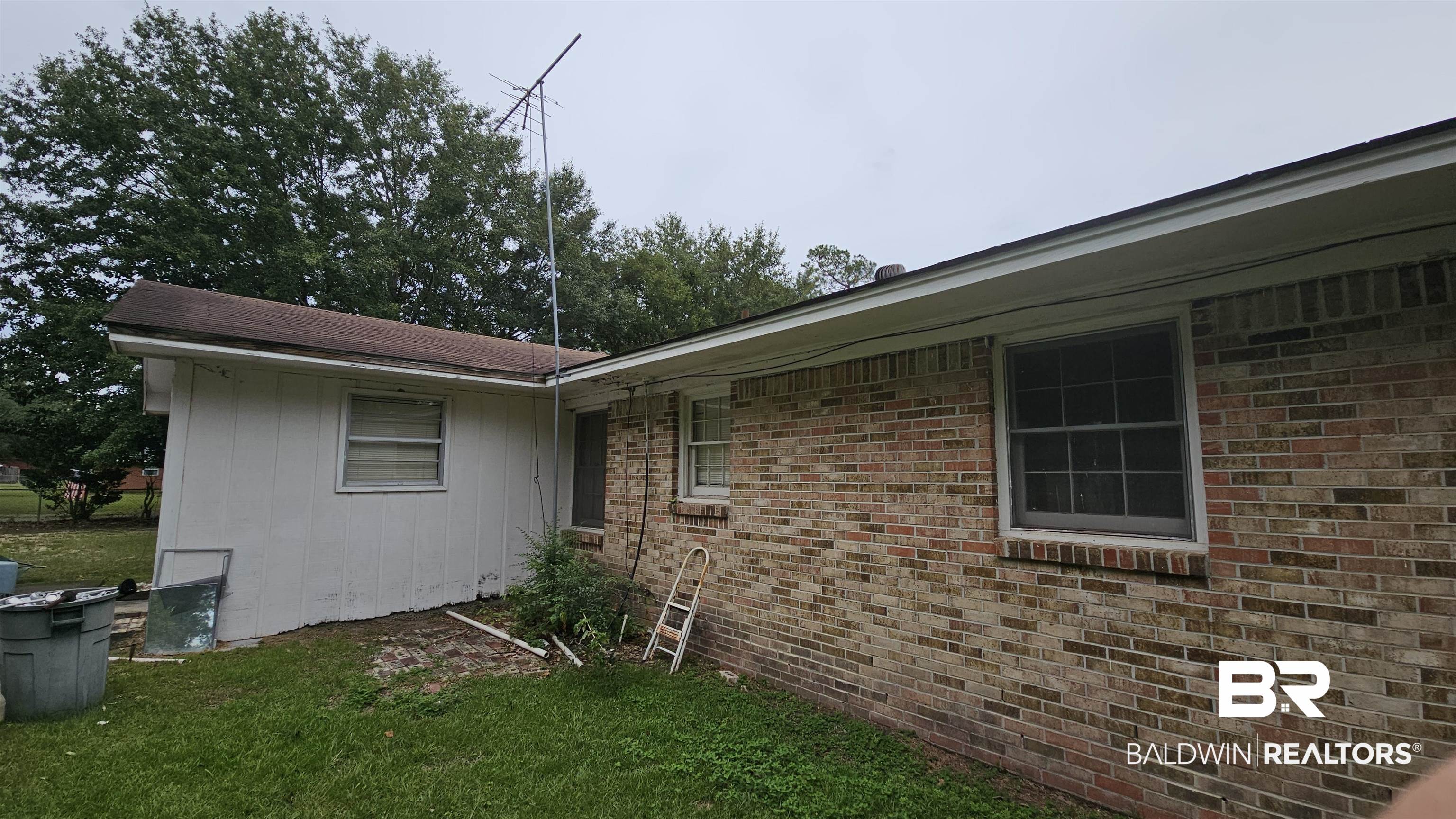216 6th Avenue Atmore, AL 36502 - Photo 28 of 34 View of property exterior with a lawn