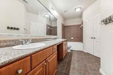 a kitchen with granite countertop a refrigerator stove and sink