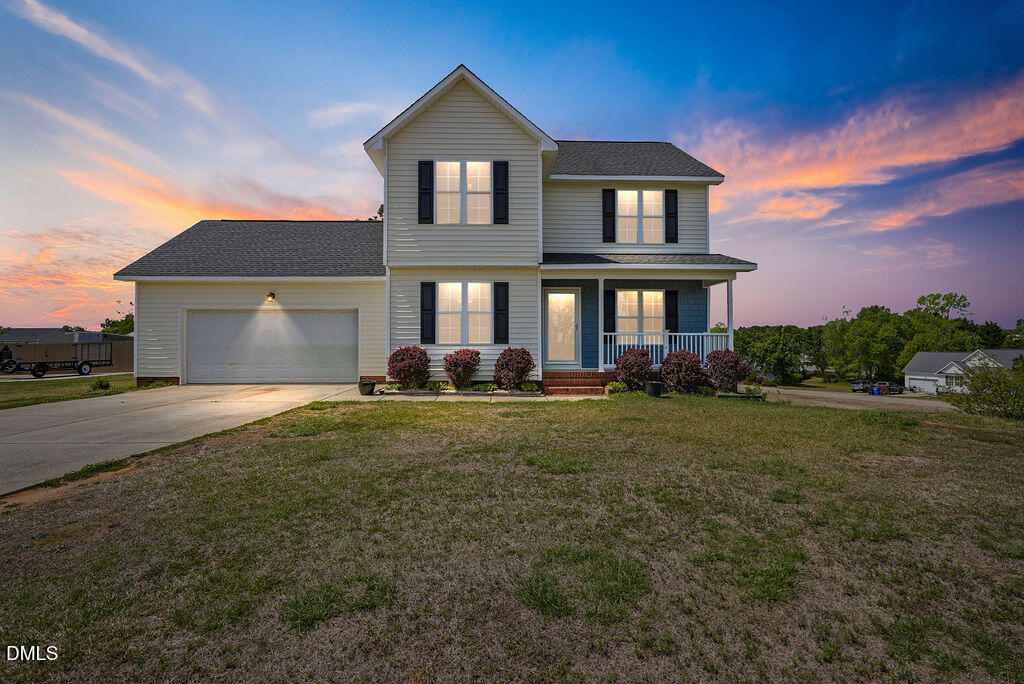 1560 Cane Mill Road Coats, NC 27521 - Photo 1 of 32 a front view of a house with garden