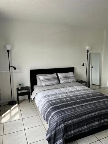 a bedroom with a bed and a cabinets