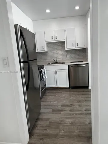 a white refrigerator freezer sitting inside of a kitchen