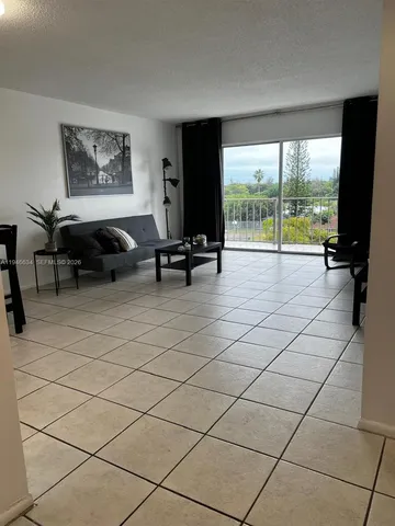 a living room with furniture and large windows
