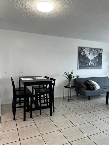 a view of a dining table and chairs in a room