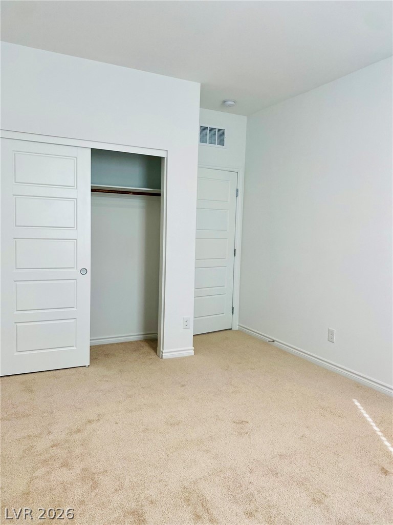 4457 Sawyer Ridge Street Las Vegas, NV 89147 - Photo 23 of 32 This spacious bedroom offers ample natural light and a practical sliding closet.