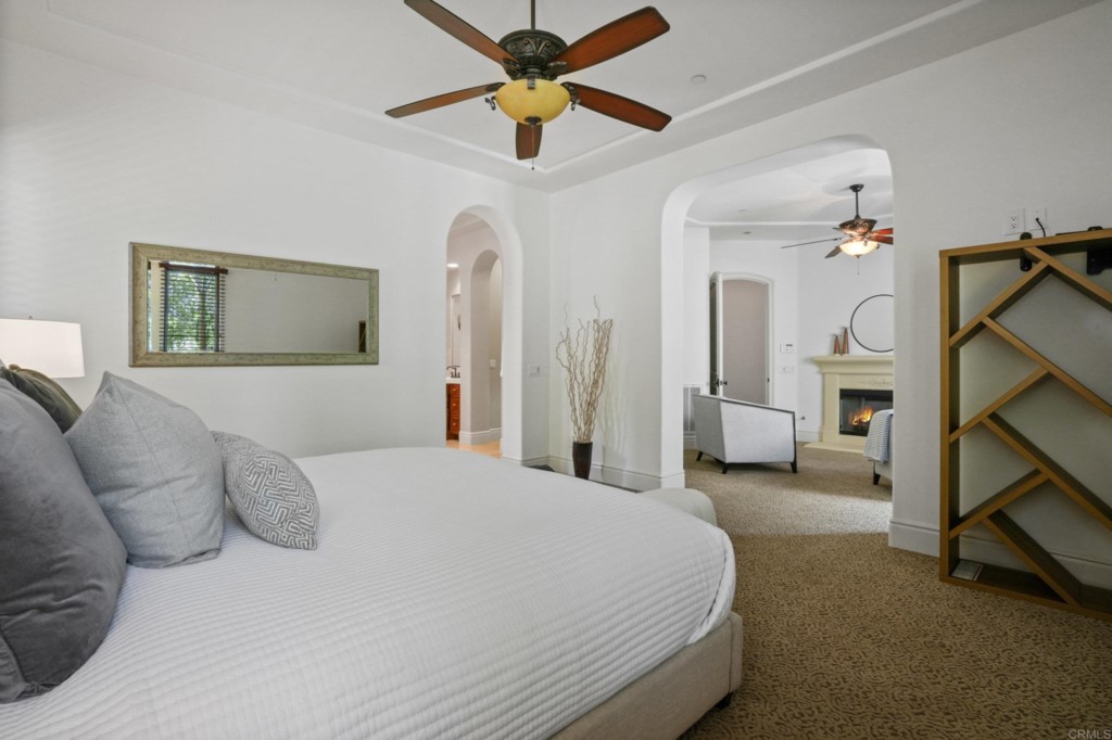 4205 Bridlewood Road Fallbrook, CA 92028 - Photo 20 of 59 a bedroom with a bed and a chandelier