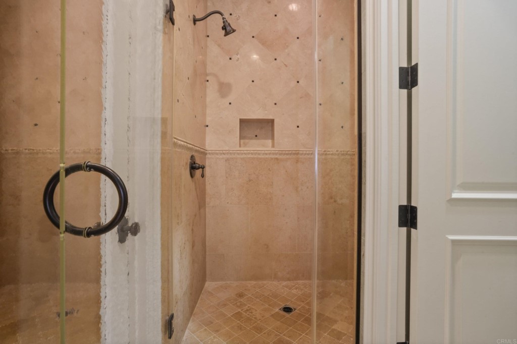 4205 Bridlewood Road Fallbrook, CA 92028 - Photo 24 of 59 a bathroom with a mirror a sink and a shower