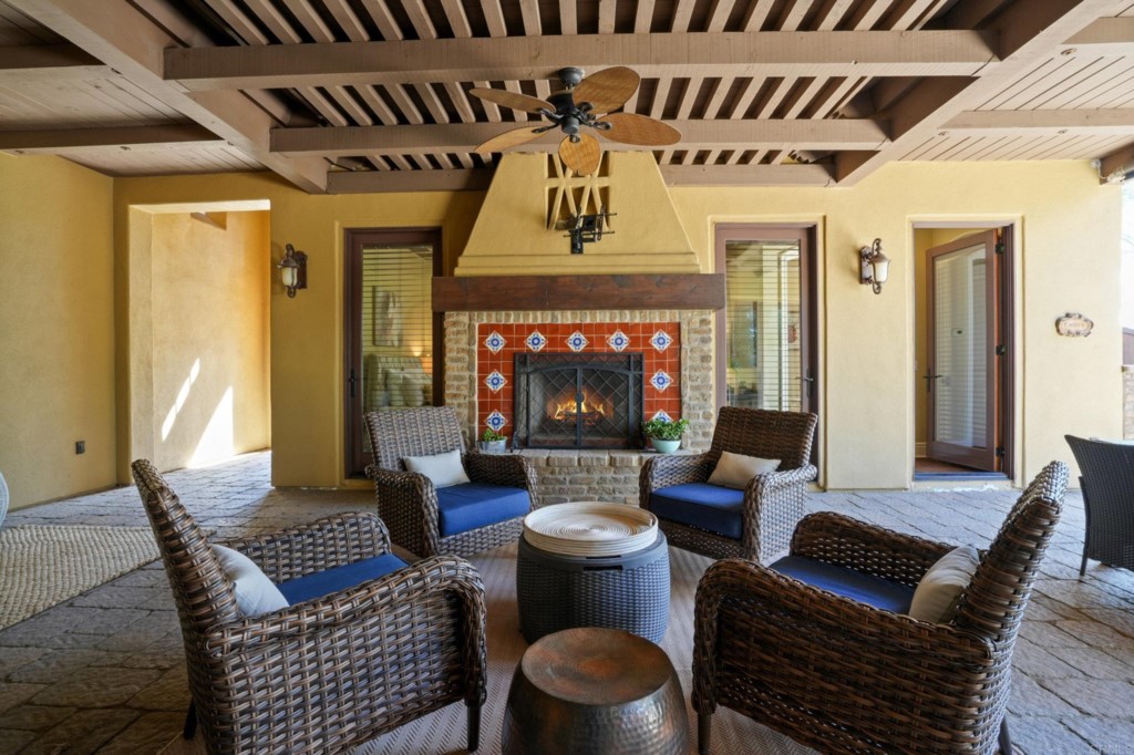 4205 Bridlewood Road Fallbrook, CA 92028 - Photo 42 of 59 a living room with furniture a fireplace and a table
