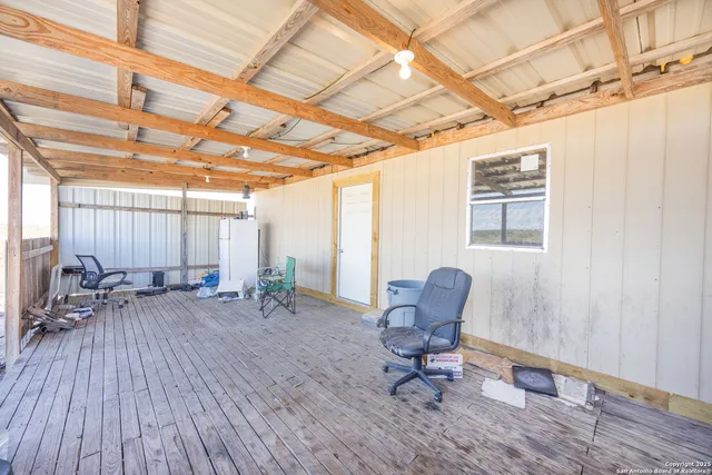 a view of a room with wooden floor and furniture